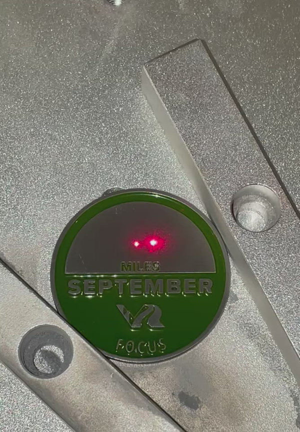 Video of monthy coin being engraved for a participants personal mileage for the month of September